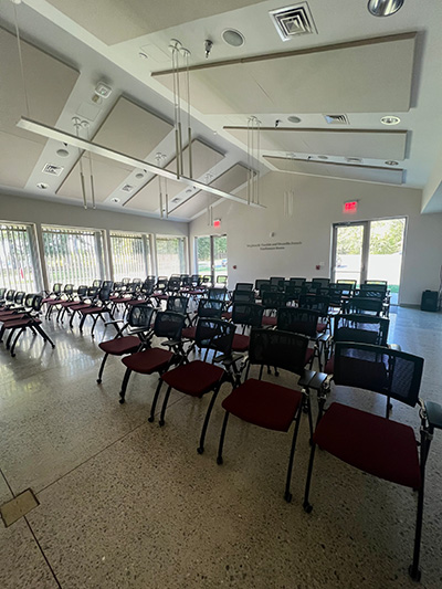 Conference room set up with rows of chairs.