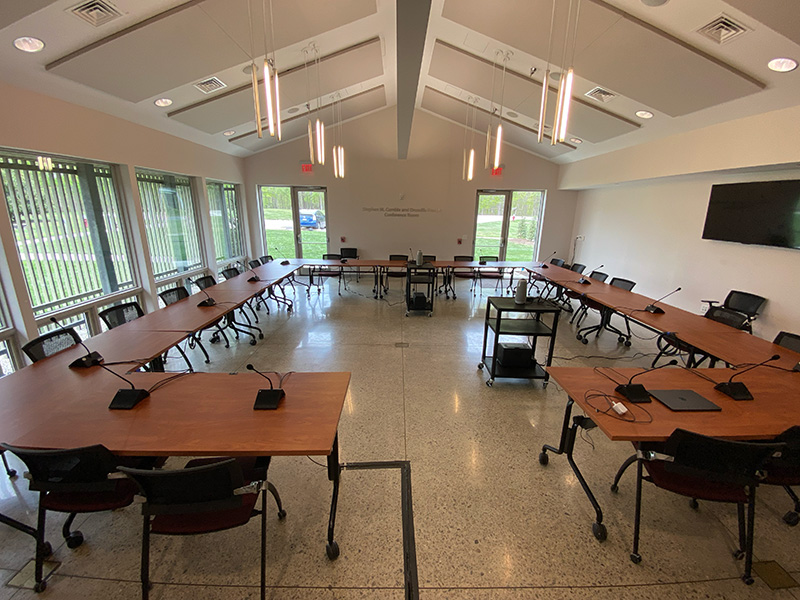 Large conference room with tables arranged in a big square